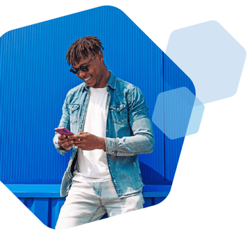 man smiling while shopping retail sites on mobile device